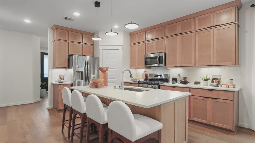 Elegant wooden cabinetry and sleek island enhance this Mostyn Springs kitchen's modern appeal. Elegant wooden cabinetry and sleek island enhance this Mostyn Springs kitchen's modern appeal.