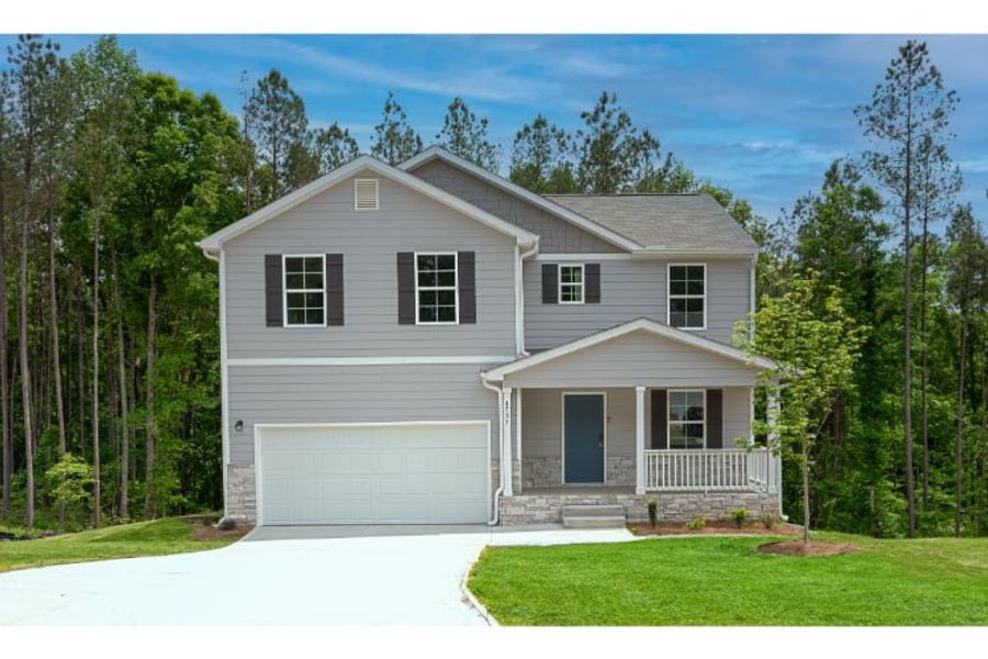 A house with a garage and trees. A house with a garage and trees.