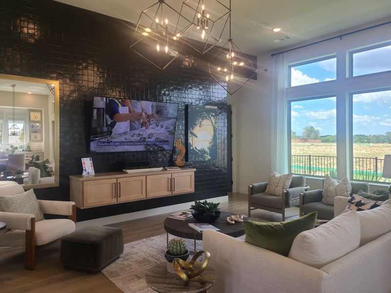 A modern living area with a glossy black accent wall, geometric lighting, and large windows overlooking a scenic view. A modern living area with a glossy black accent wall, geometric lighting, and large windows overlooking a scenic view.
