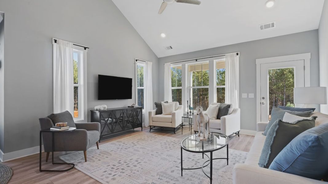 Two story family room with trendy decor, large windows and yard access in Anderson, SC at Village at Midway by DRB Homes Two story family room with trendy decor, large windows and yard access in Anderson, SC at Village at Midway by DRB Homes