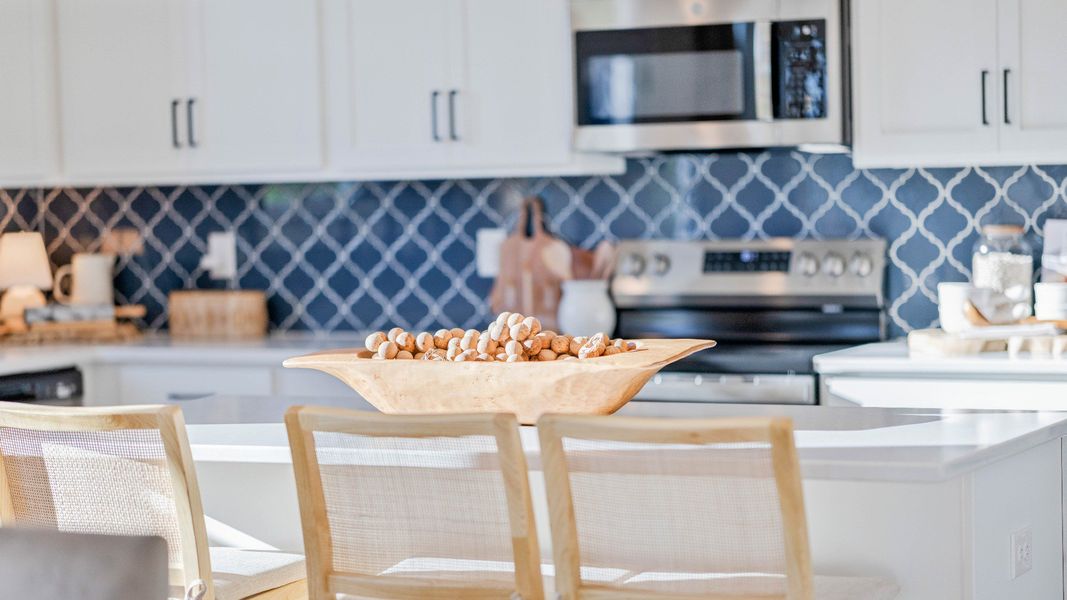 Corner kitchen with tile backsplash and center island Corner kitchen with tile backsplash and center island