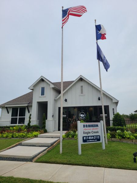 A charming white home with lush landscaping at Eagle Creek by D.R. Horton in Denton, TX. A charming white home with lush landscaping at Eagle Creek by D.R. Horton in Denton, TX.