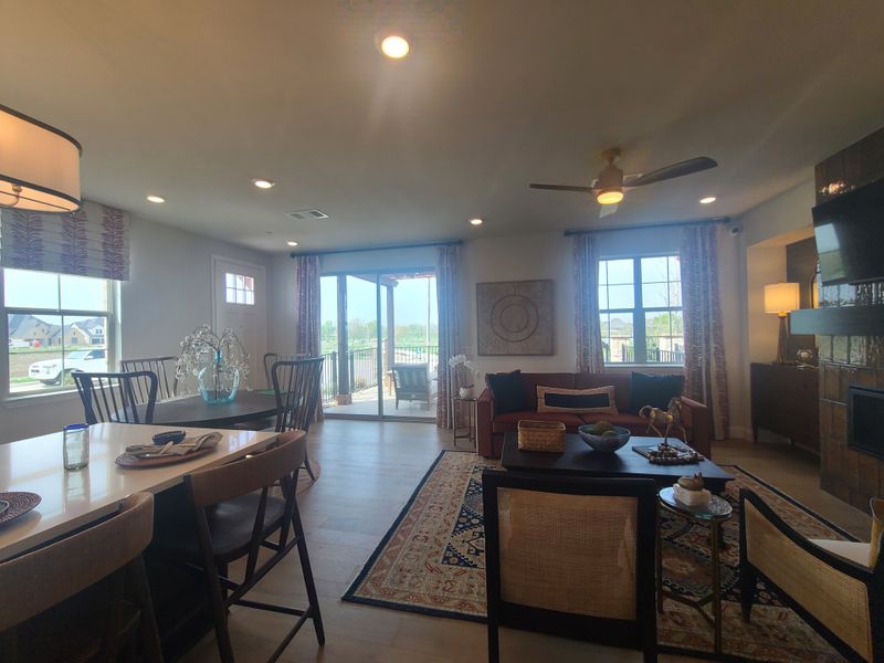 A bright, open-concept living and dining area with modern décor, cozy seating, and large windows bringing in natural light. A bright, open-concept living and dining area with modern décor, cozy seating, and large windows bringing in natural light.