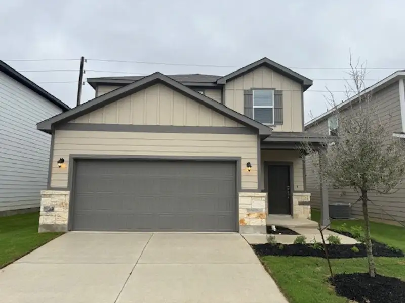 A modern two-story home with a gray exterior and a tidy yard in University Village by Century Communities (San Antonio, TX). A modern two-story home with a gray exterior and a tidy yard in University Village by Century Communities (San Antonio, TX).