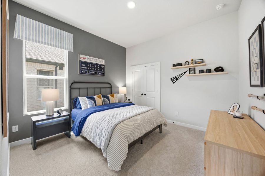 A bedroom with a bed and a desk. A bedroom with a bed and a desk.