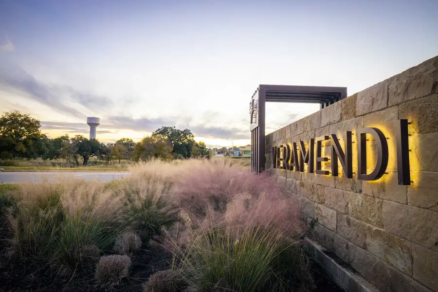 Entrance to the Veramendi: 1/2 Acre + Lots community in New Braunfels, TX, featuring signage and landscaping (Image 1).
