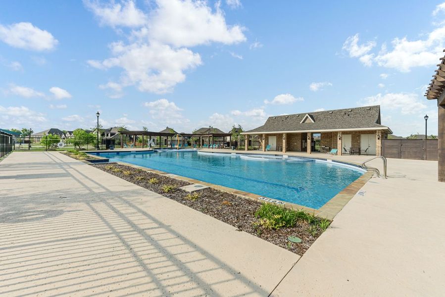 Community pool with large deck, covered pavilion, and brick clubhouse building nearby Community pool with large deck, covered pavilion, and brick clubhouse building nearby