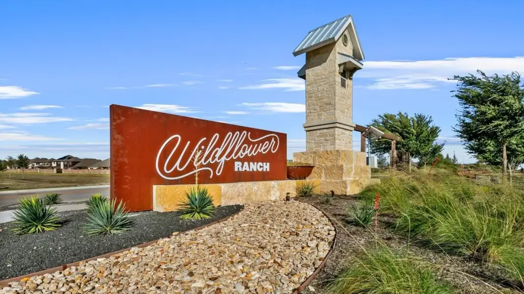 Entrance to the Wildflower Ranch community in Justin, TX, featuring signage and landscaping (Image 2).