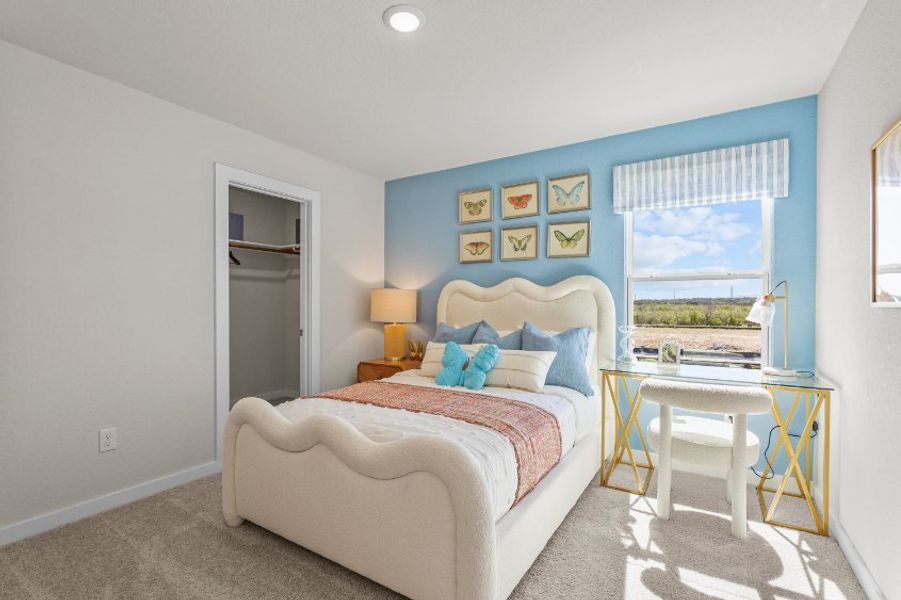 A bedroom with a bed and a table.