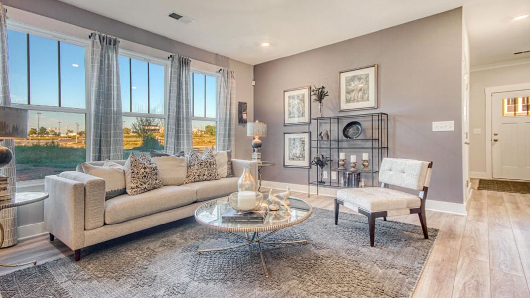 Litchfield design bright family room with large windows and premium finishes. Leigh Park by DRB Homes. Charlotte, NC.