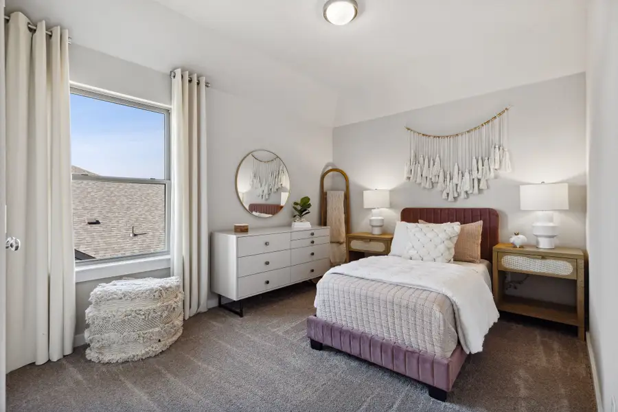 Bedroom in an Oak Model Home by Trophy Signature Homes