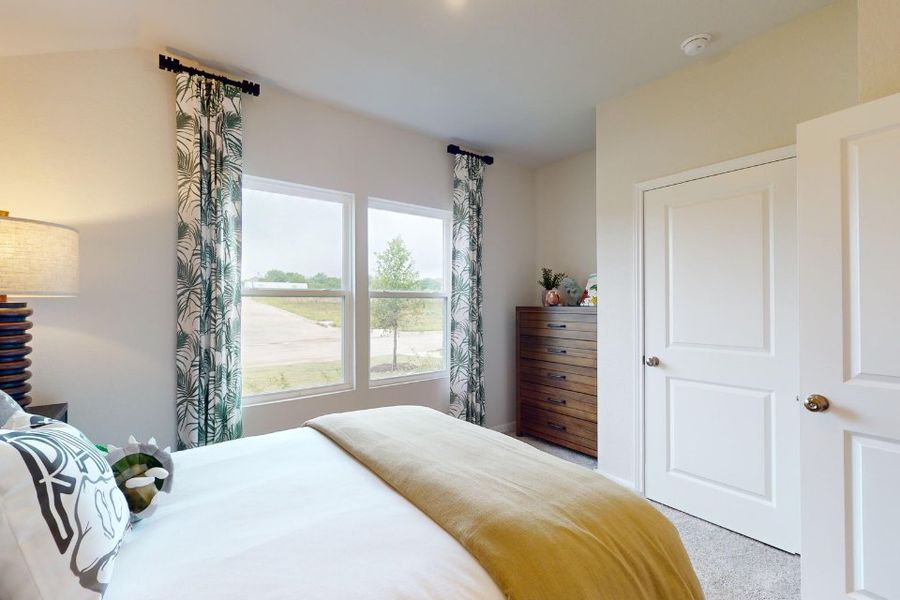 A bedroom with a large window. A bedroom with a large window.