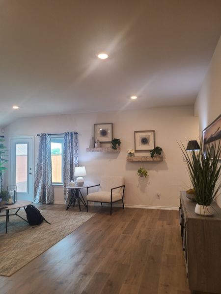 A cozy living room featuring wood flooring, stylish decor, and natural light enhancing the peaceful ambiance.