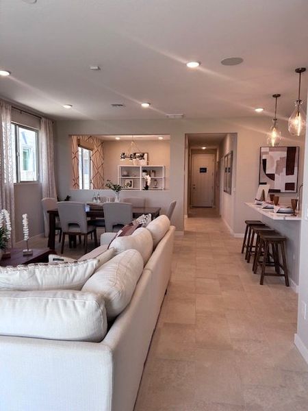 An open-concept living area with cozy seating, dining space, and modern lighting creates a warm and inviting atmosphere. An open-concept living area with cozy seating, dining space, and modern lighting creates a warm and inviting atmosphere.