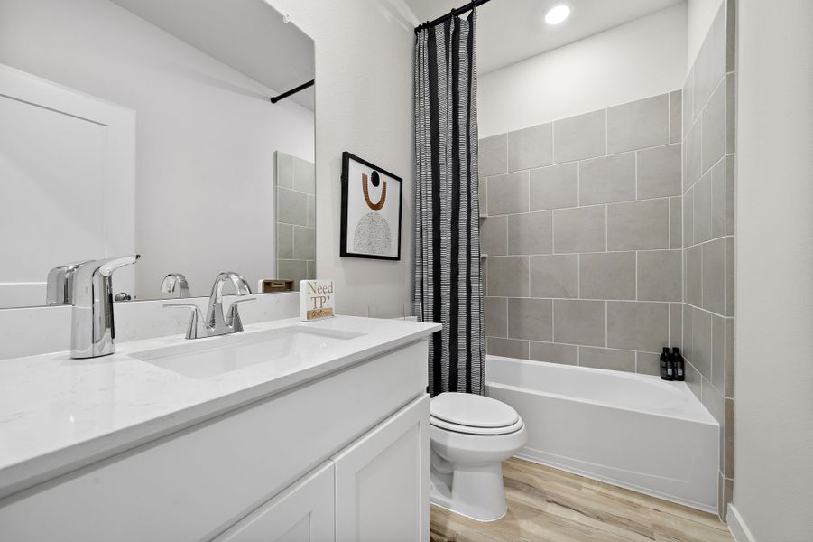A bathroom with a tub sink and toilet. A bathroom with a tub sink and toilet.
