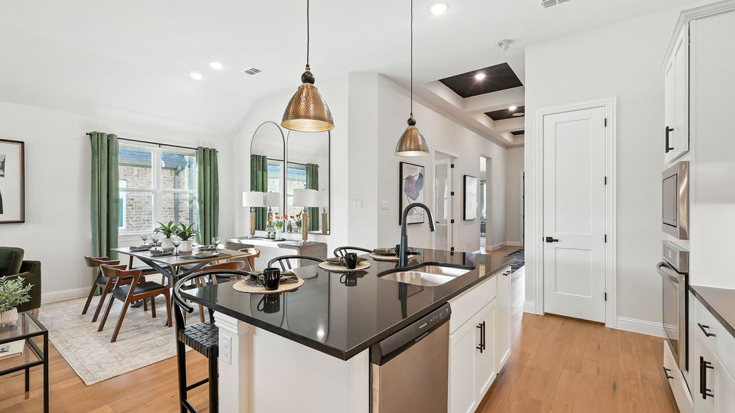 Sleek black countertops and luxurious hardwood floors make this kitchen a standout in Green Oaks Preserve. Sleek black countertops and luxurious hardwood floors make this kitchen a standout in Green Oaks Preserve.