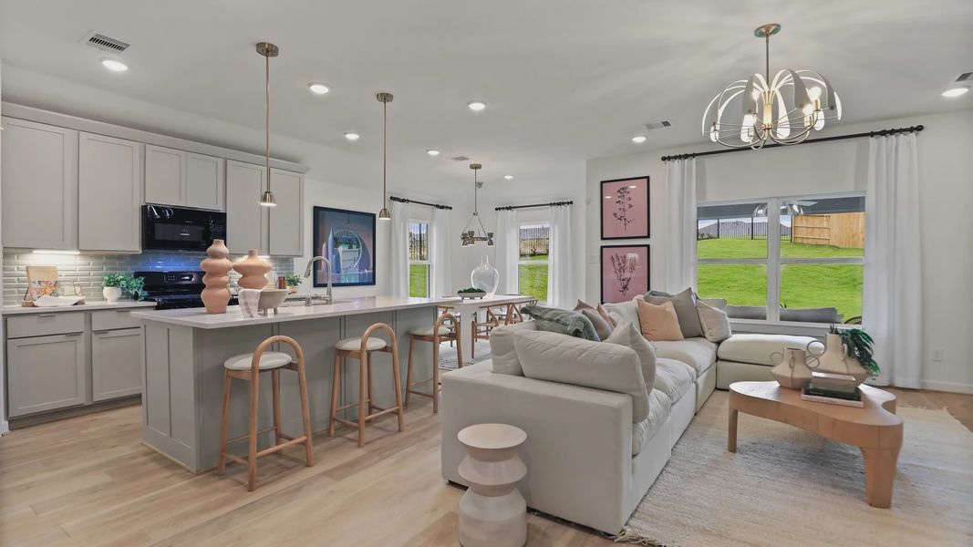 Luxurious open layout in Mostyn Springs featuring high-end lighting, chic kitchen island, and large windows. Luxurious open layout in Mostyn Springs featuring high-end lighting, chic kitchen island, and large windows.