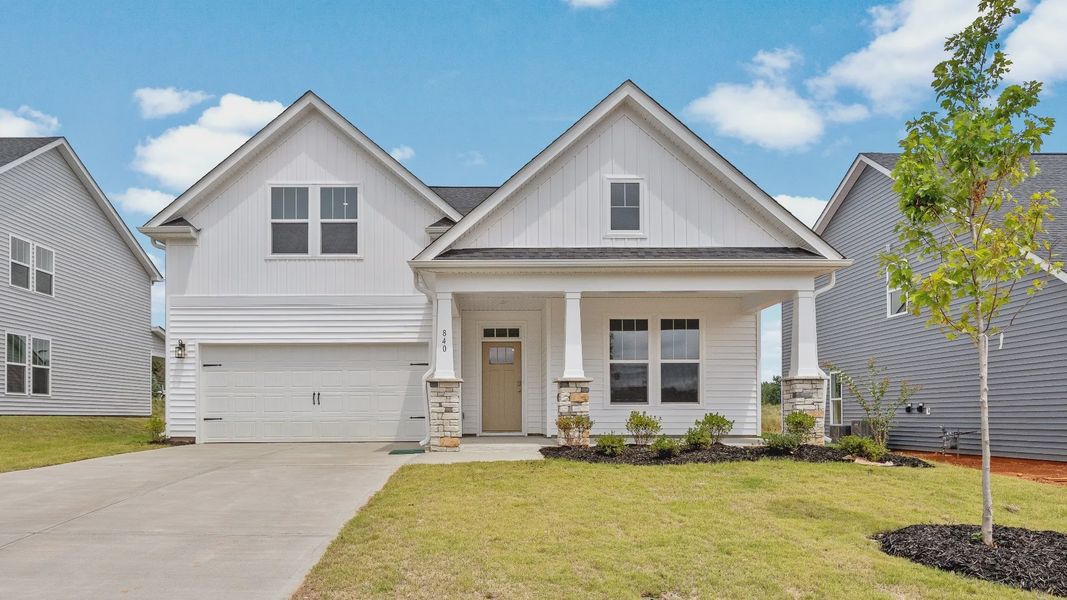 DRB Homes' Walnut Ridge community featuring the Cooper 3 in a stunning bright white exterior with stone detailed columns