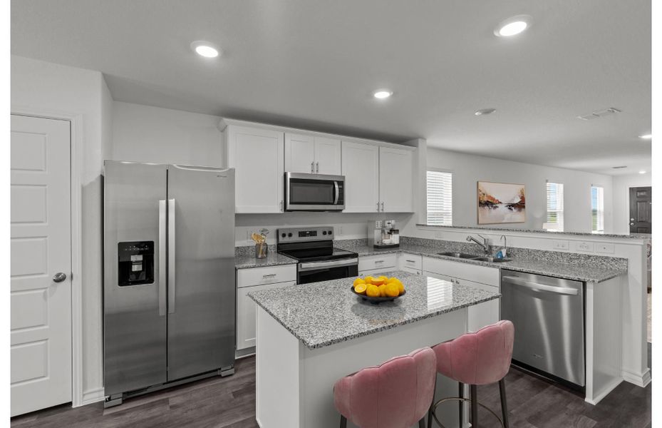 Open kitchen with White Cabinets and Stainless Steel Appliances