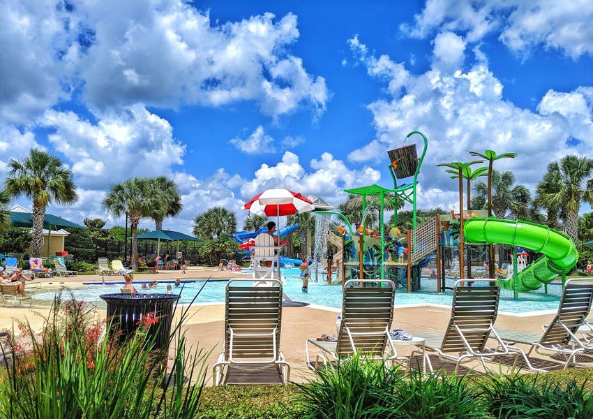 A lively community pool with slides and sun loungers in Sienna - 45' by Westin Homes, Missouri City, TX.