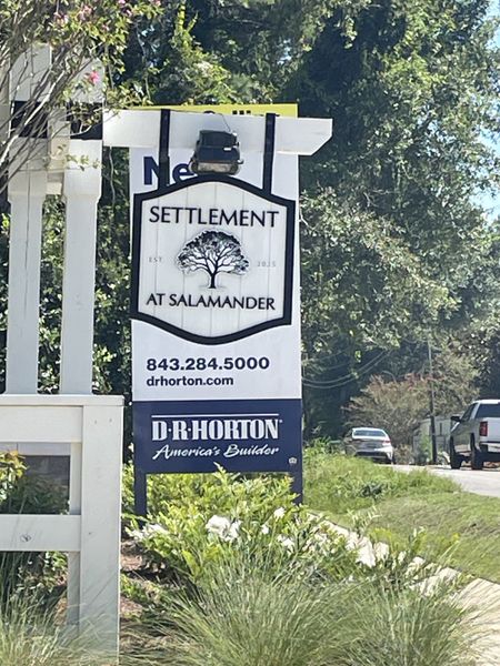 A welcoming entrance to Settlement at Salamander by D.R. Horton, set amidst lush greenery in North Charleston, SC. A welcoming entrance to Settlement at Salamander by D.R. Horton, set amidst lush greenery in North Charleston, SC.