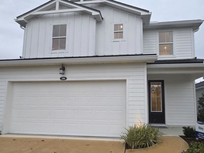 A charming white home with a modern exterior in RiverTown - Bluffs by Mattamy Homes (St. Johns, FL).