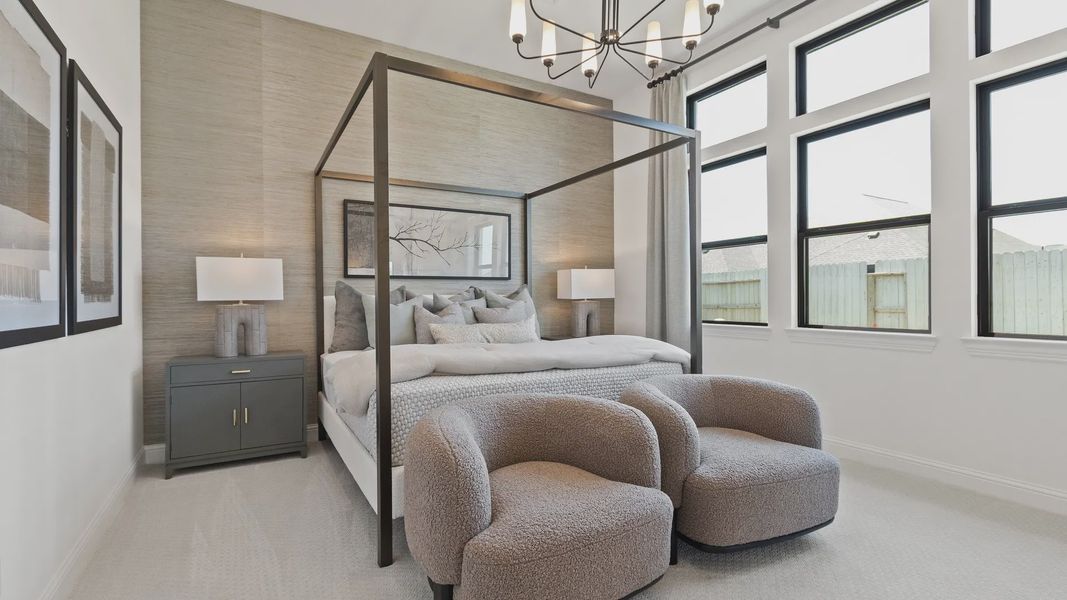 Elegant canopy bed, plush seating, and modern chandelier elevate Oakwood Estates' master bedroom. Elegant canopy bed, plush seating, and modern chandelier elevate Oakwood Estates' master bedroom.