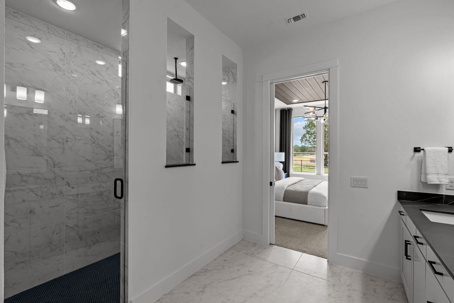 Spa-inspired primary bath with luxurious finishes and serene, relaxing atmosphere. Spa-inspired primary bath with luxurious finishes and serene, relaxing atmosphere.