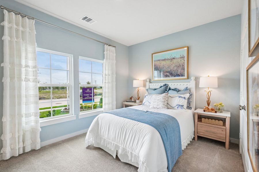A bedroom with a bed and a window.