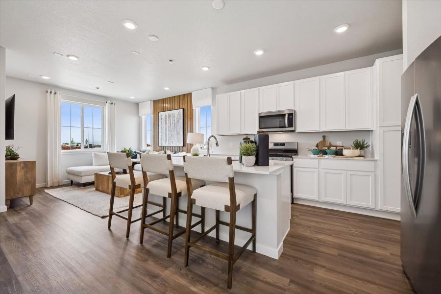 A kitchen with white cabinets.