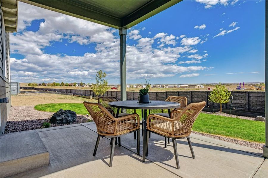 A table and chairs on a patio.