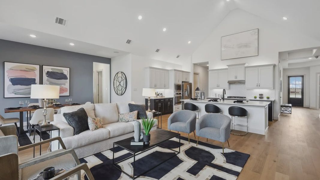 Spacious open-concept layout with vaulted ceilings, chic decor, and premium finishes in Westside Preserve.