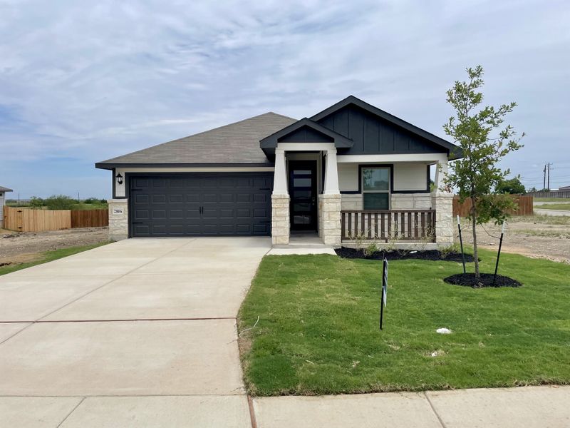 A modern home with stone accents and a tidy lawn in Royal Crest by Meritage Homes (San Antonio, TX). A modern home with stone accents and a tidy lawn in Royal Crest by Meritage Homes (San Antonio, TX).