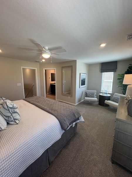 A cozy bedroom with a plush bed, seating area, and neutral tones, complemented by modern decor and ample natural light. A cozy bedroom with a plush bed, seating area, and neutral tones, complemented by modern decor and ample natural light.