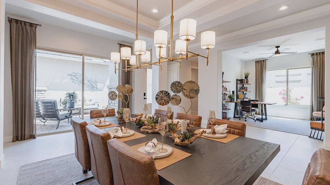 Experience refined elegance with chic lighting and supple leather seating in this Windrose dining space.