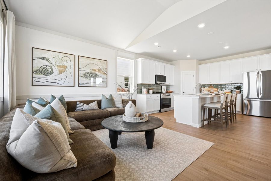 A living room with a couch and a table. A living room with a couch and a table.