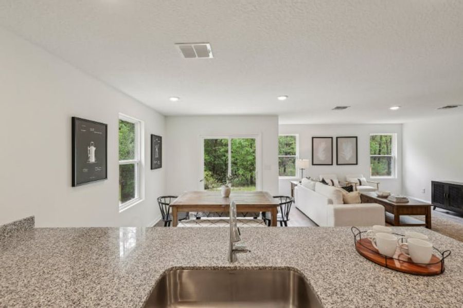 A living room with a large table and chairs.