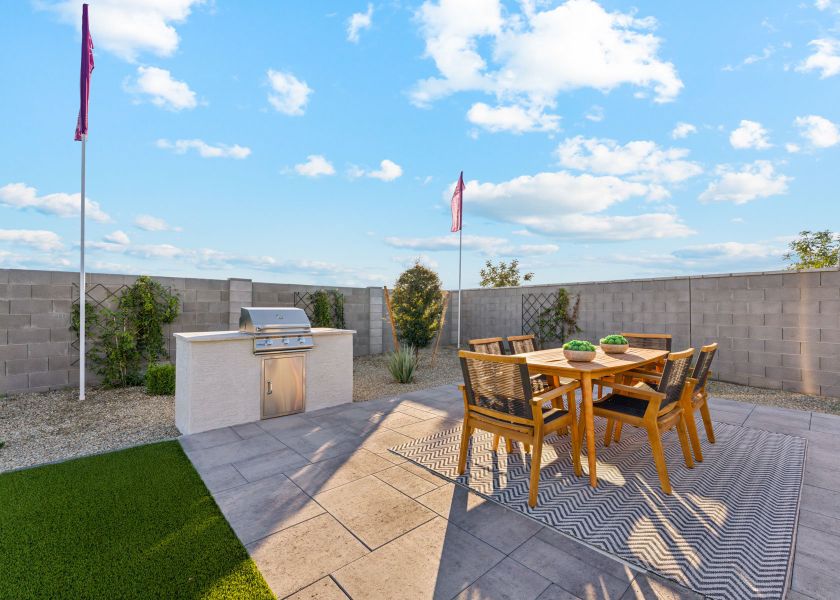 A patio with a table and chairs.