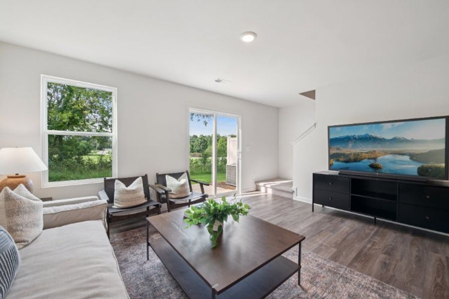 A living room with a large television. A living room with a large television.