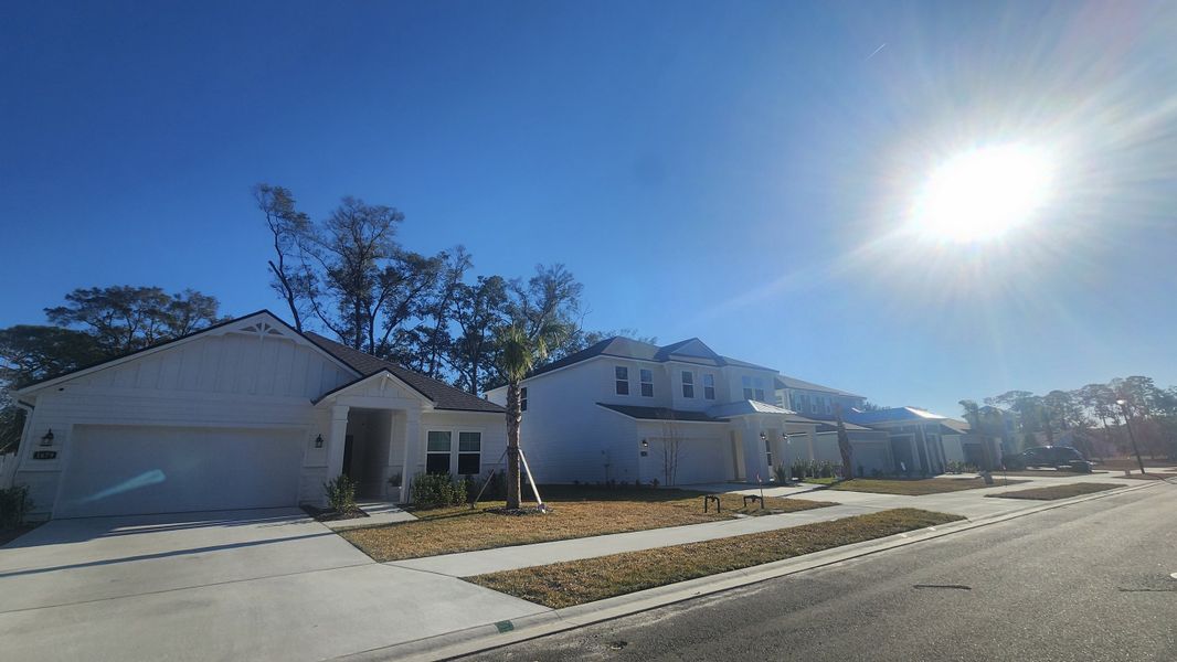 A sunny street view of modern homes in Oak Creek Preserve by Century Communities, Jacksonville, FL.