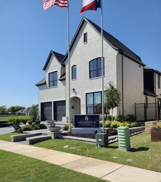 Elegant white-brick home with sleek design in Brookhollow West by Shaddock Homes (Prosper, TX). Elegant white-brick home with sleek design in Brookhollow West by Shaddock Homes (Prosper, TX).