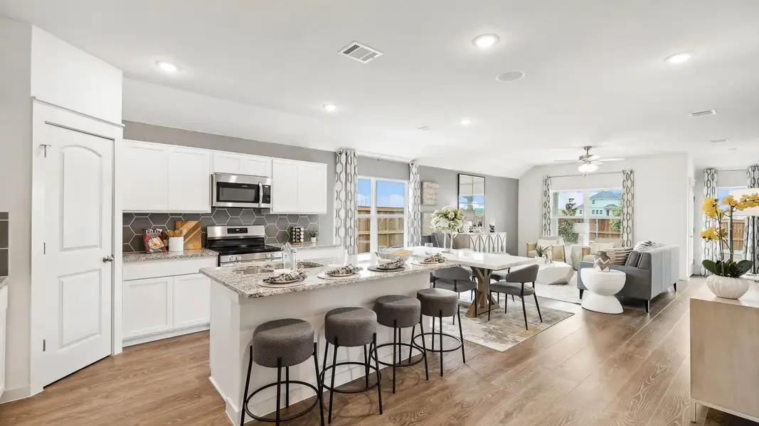 Luxurious open-plan kitchen with elegant granite counters and premium hardwood flooring in Still Water Lake Estates.