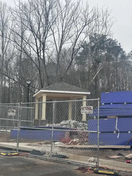 A construction site with a pavilion and trees in Echo Park by UnionMain Homes, located in Suwanee, GA.