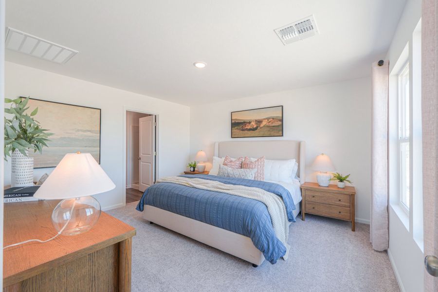 A bedroom with a bed and lamps. A bedroom with a bed and lamps.