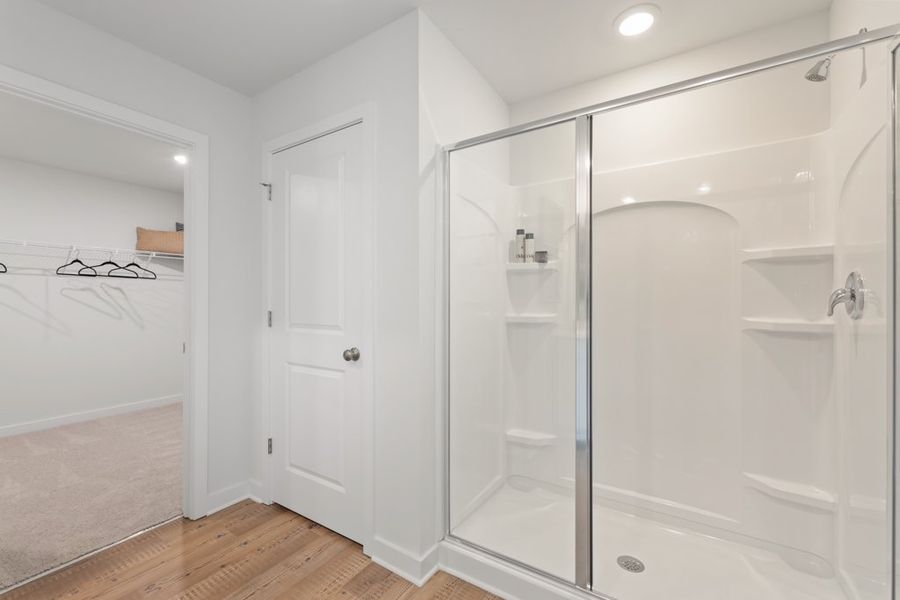 A bathroom with a glass shower. A bathroom with a glass shower.
