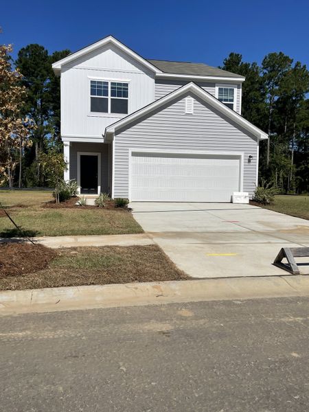 A modern gray siding home with a clean driveway in Watson Hill by Starlight Homes, Summerville, SC. A modern gray siding home with a clean driveway in Watson Hill by Starlight Homes, Summerville, SC.