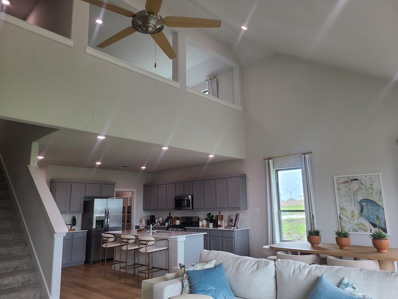 A spacious, airy open-concept living area with a modern kitchen, cozy seating, and stylish decor.