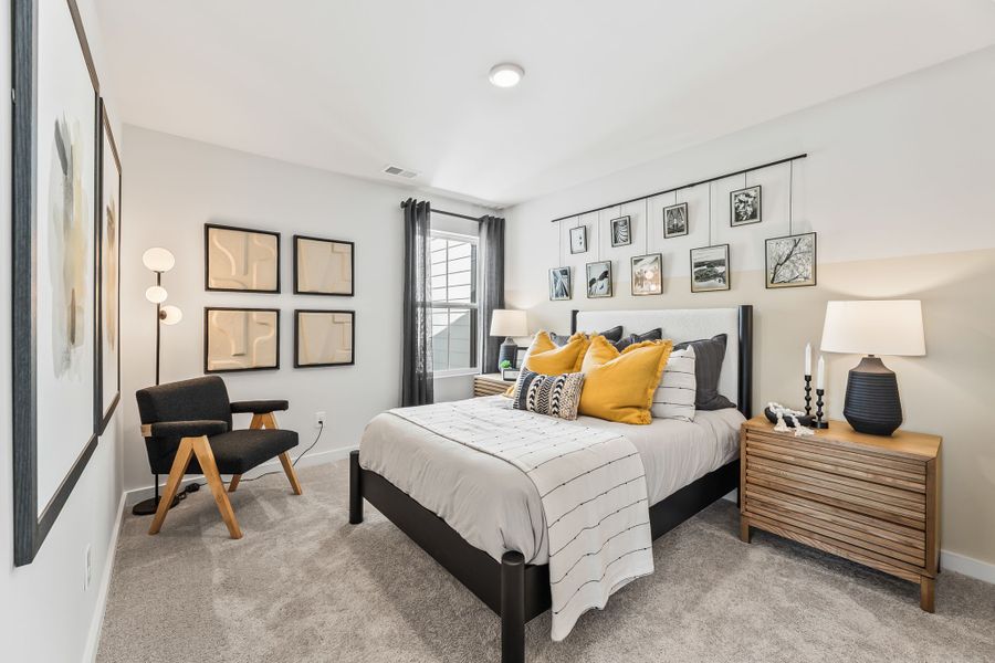 A bedroom with a bed and a chair. A bedroom with a bed and a chair.