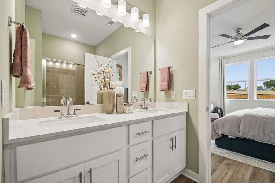 A bathroom with a large mirror.
