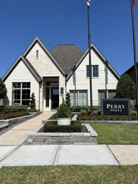 A beautiful white brick home with manicured landscaping in Sienna 65' - Valencia by Perry Homes (Missouri City, TX). A beautiful white brick home with manicured landscaping in Sienna 65' - Valencia by Perry Homes (Missouri City, TX).